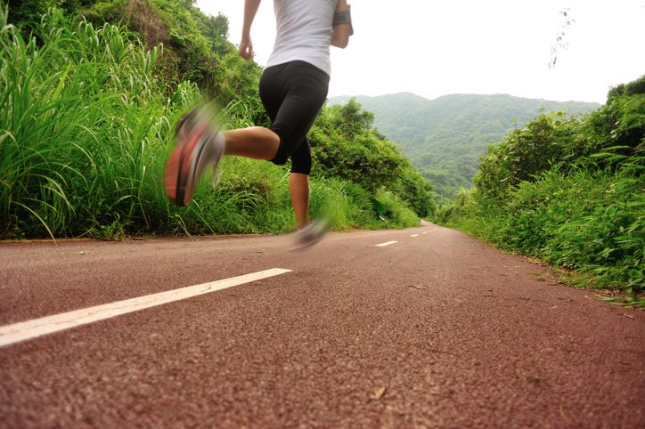 runner going downhill road